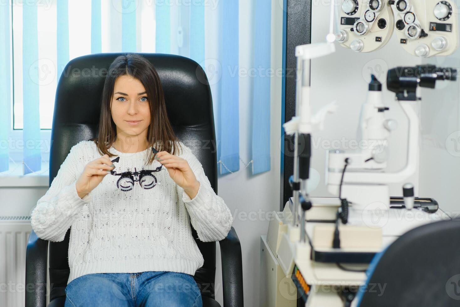 Selection of glasses for sight for the woman. The correct selection of points. Optical Salon. Optician. Trial lenses photo