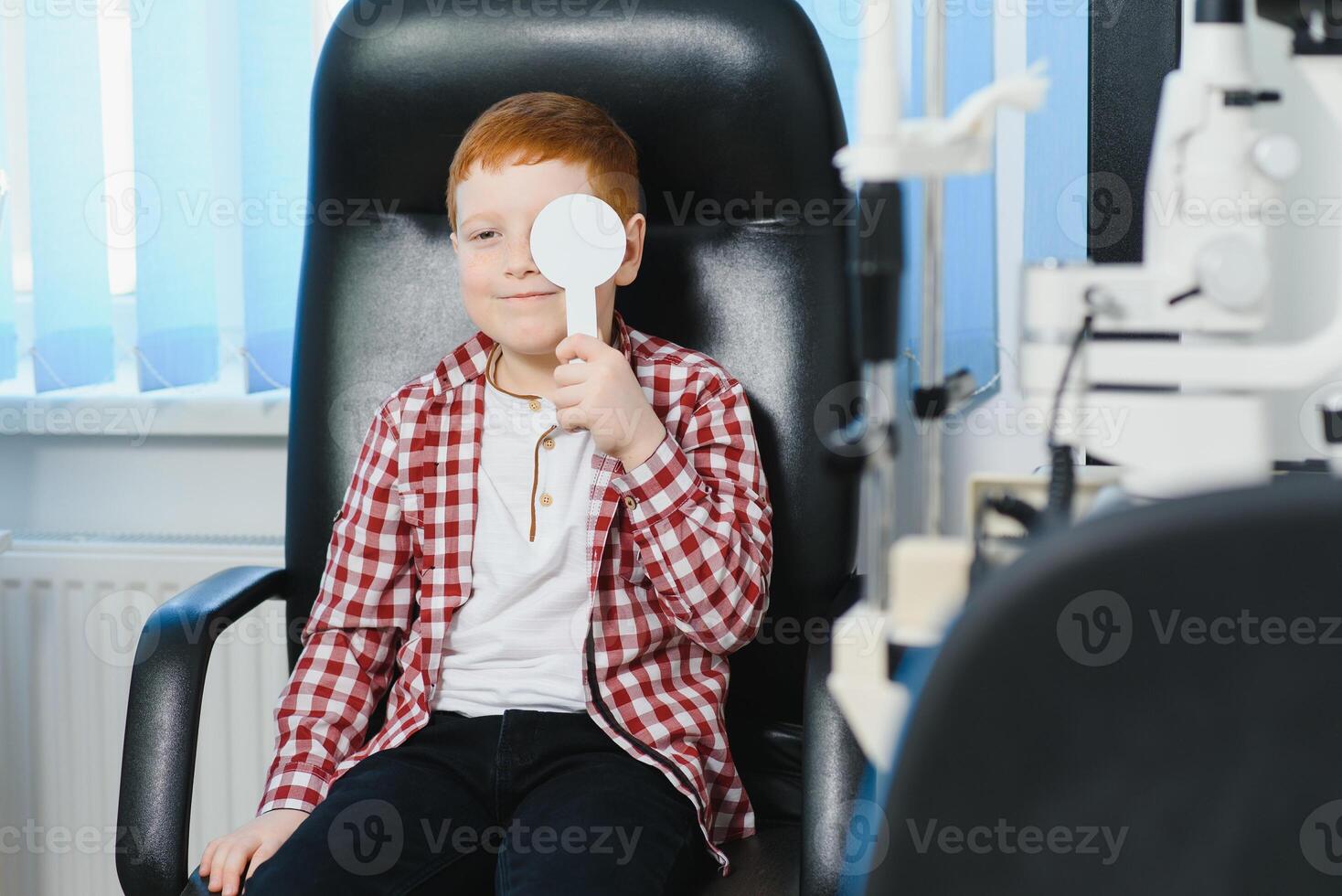 Child at eye sight test. Little kid selecting glasses at optician store. Eyesight measurement for school kids. Eye wear for children. Doctor performing eye check. Boy with spectacles at letter chart photo