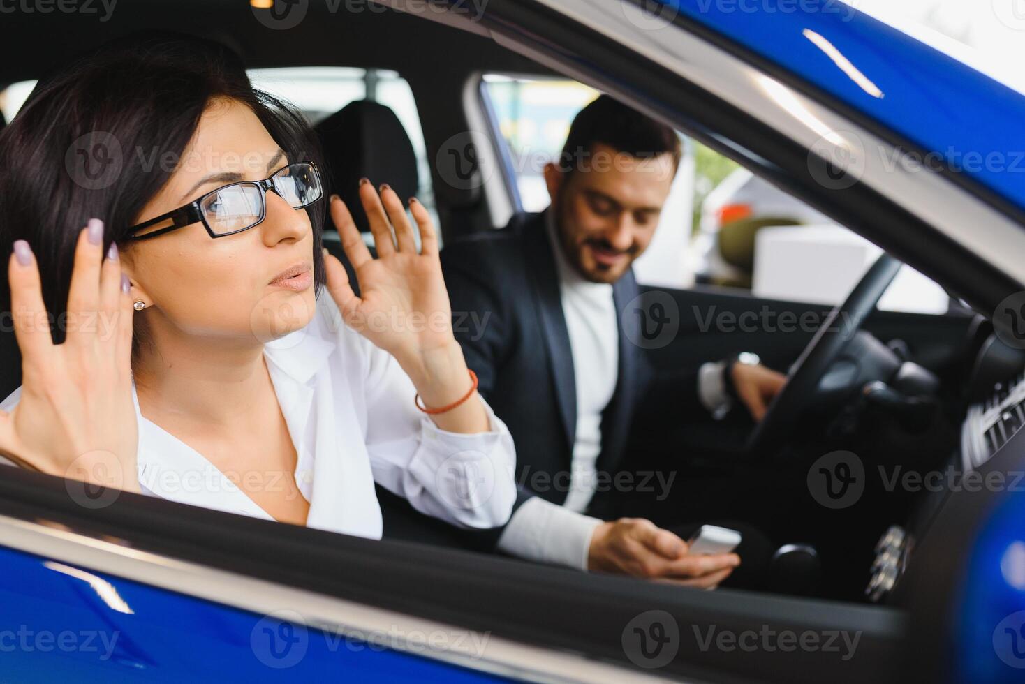 Young business people working together while traveling by a car. photo