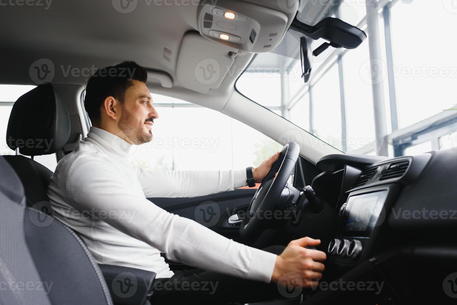 Male hand on the shift lever of the transmission in the car photo