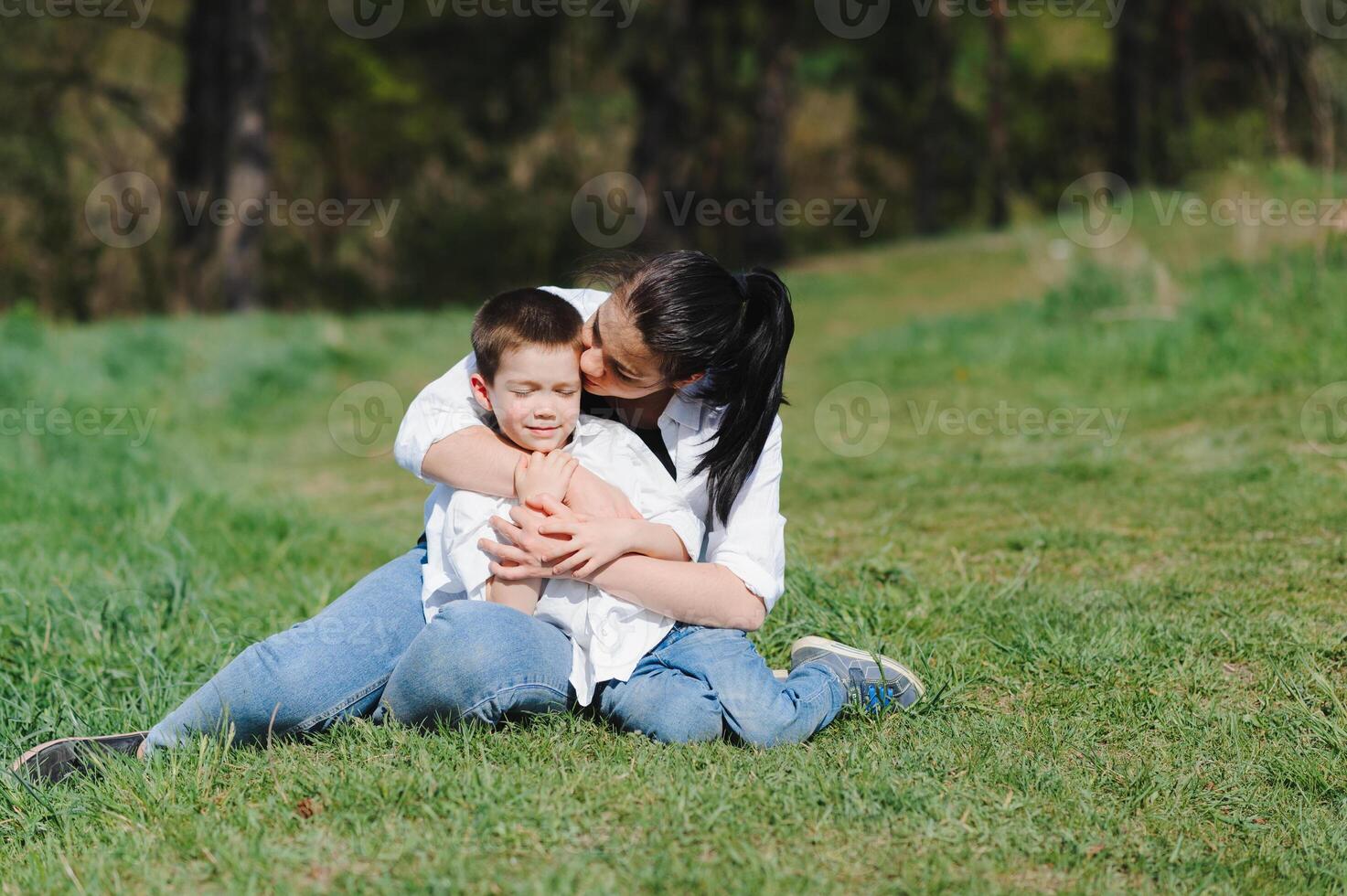 Happy family. Mother with son child playing having fun together on the grass in sunny summer day, life moment photo