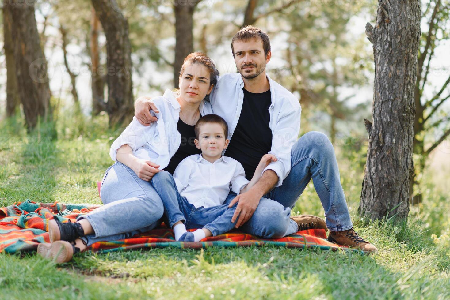 happy young couple with their children have fun at beautiful park outdoor in nature photo