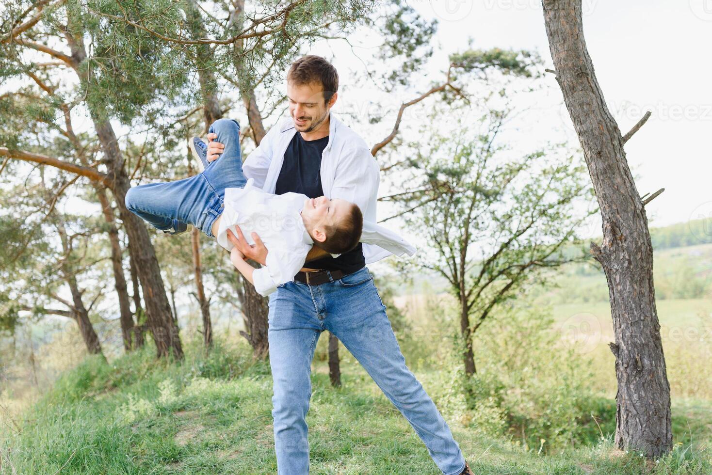 father and son have fun together in nature. Father and son playing. People having fun outdoors. Concept of friendly family. photo