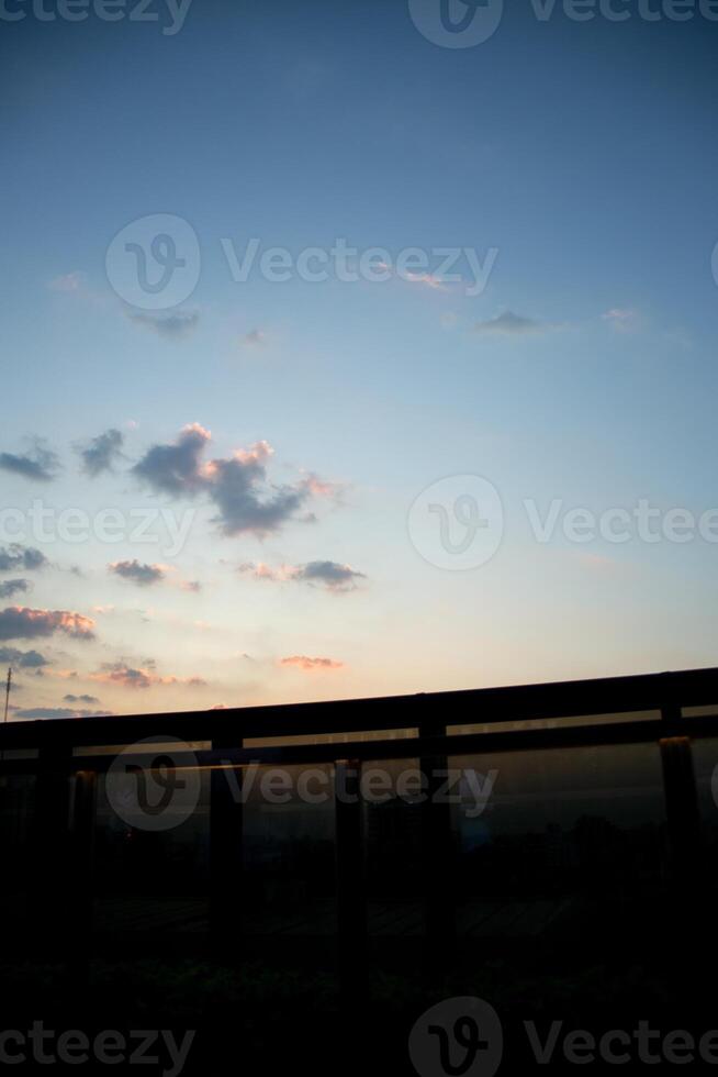 orange blue skyscape background with cloud and city town building in evening of the day sunset twilight dusk time photo