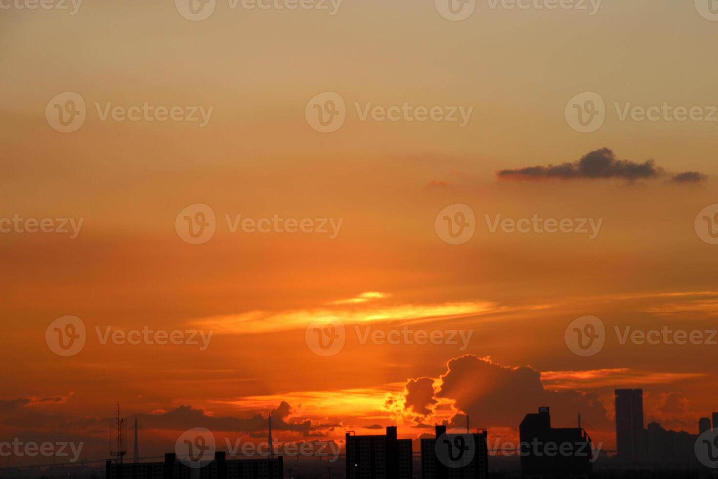 orange blue skyscape background with cloud and city town building in evening of the day sunset twilight dusk time photo