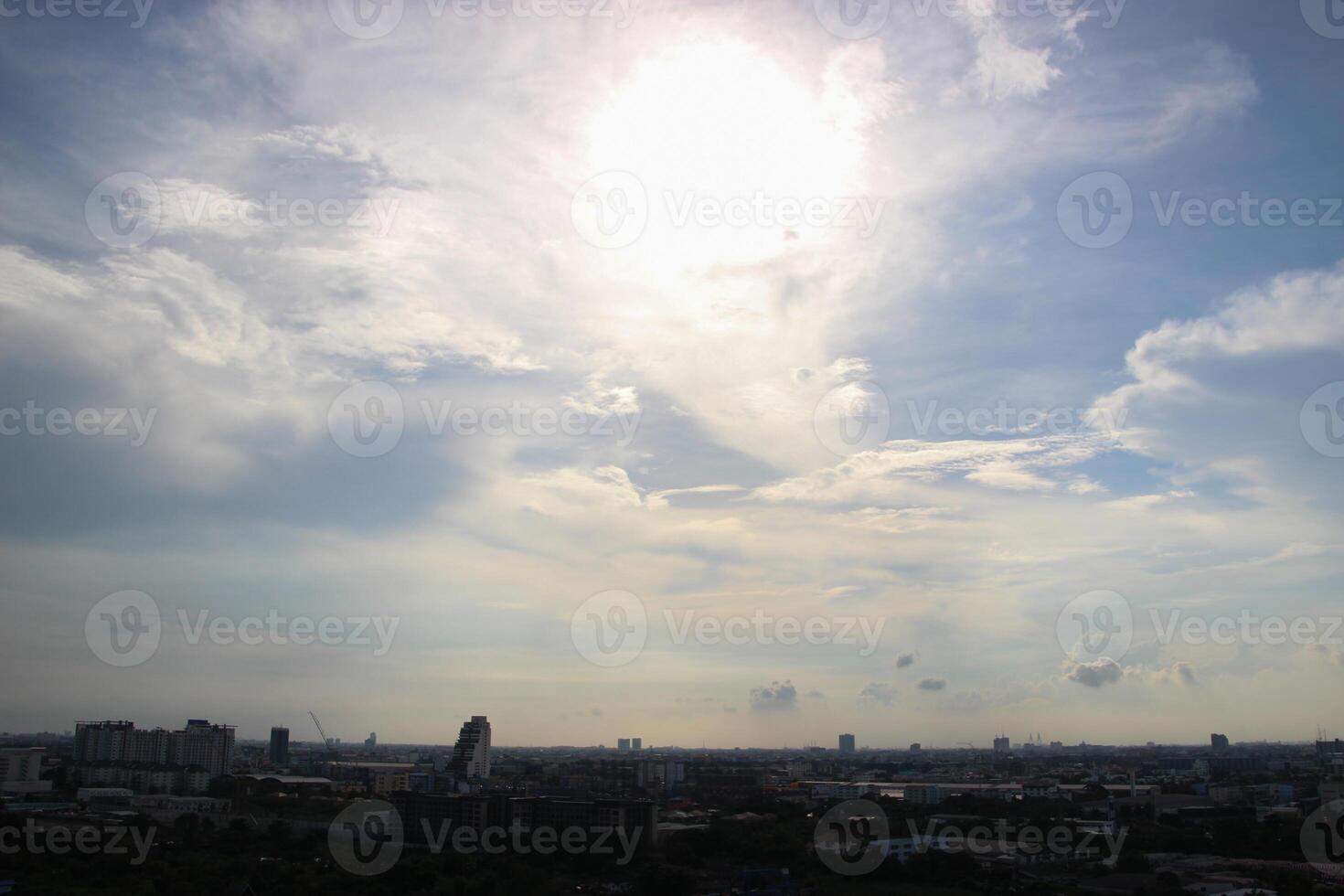 silhouette shadow of a tree and city building town with sunset and cloud sky background photo