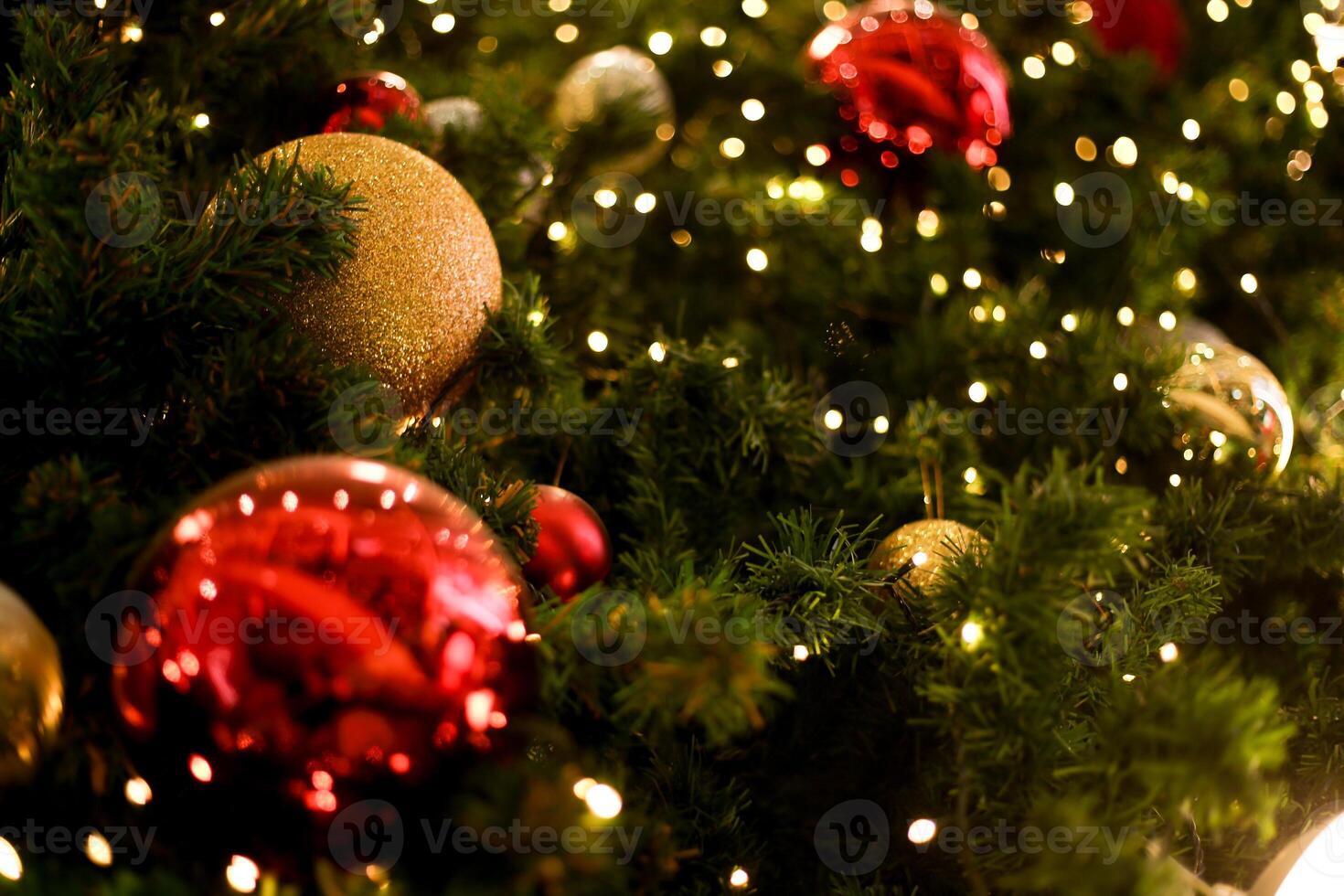 close up decoration ball and light bulb bokeh on Christmas tree at night time on holiday xmas theme photo