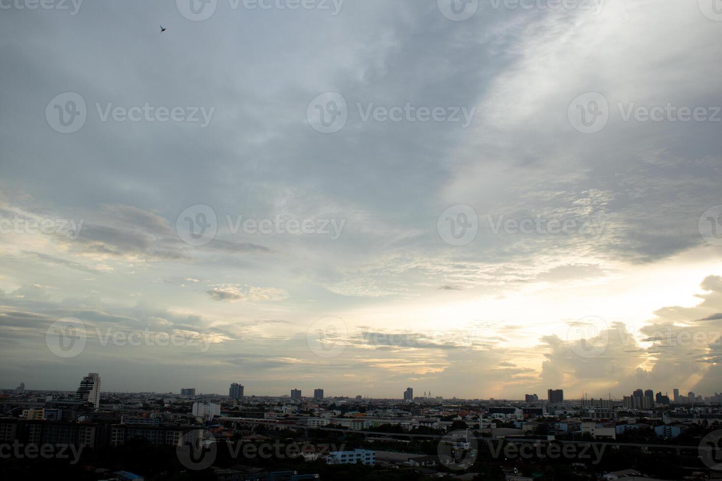 reflection light sun ray from beside white clouds in cloudy daytime with dusk sunrise sunset twilight time sky with city high view photo