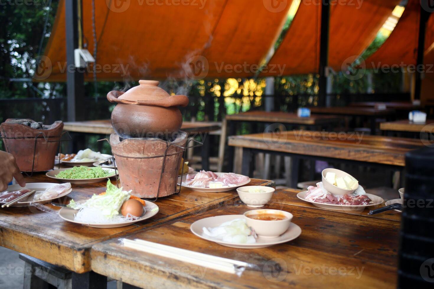 Jim Jum ,Thai Hot Pot with Clear Soup with Eggs, glass noodles, raw pork serve with Charcoal stove photo