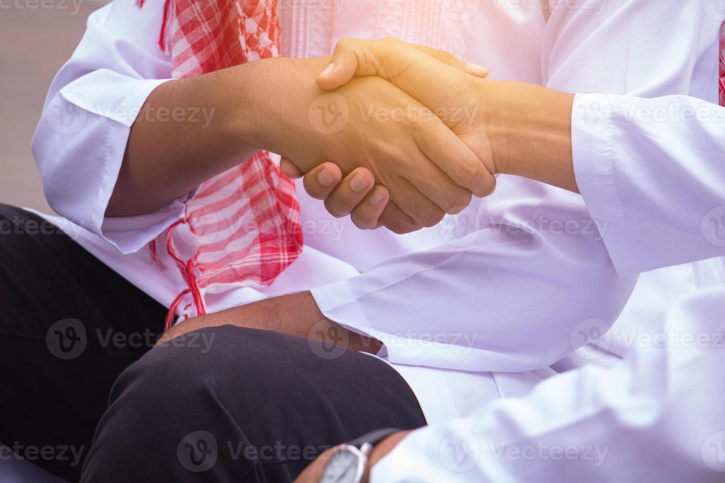 Islamic business man.They are Shaking hands and Gladness in work.They are Successful in business.Arabic Business Concept photo