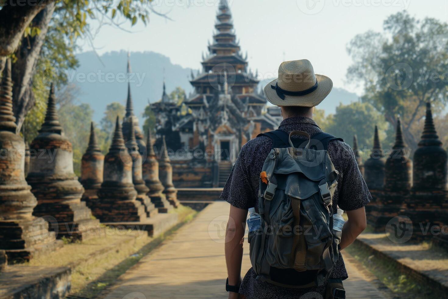 Back view of a traveler man with backpack at Myanmar ancient pagoda photo