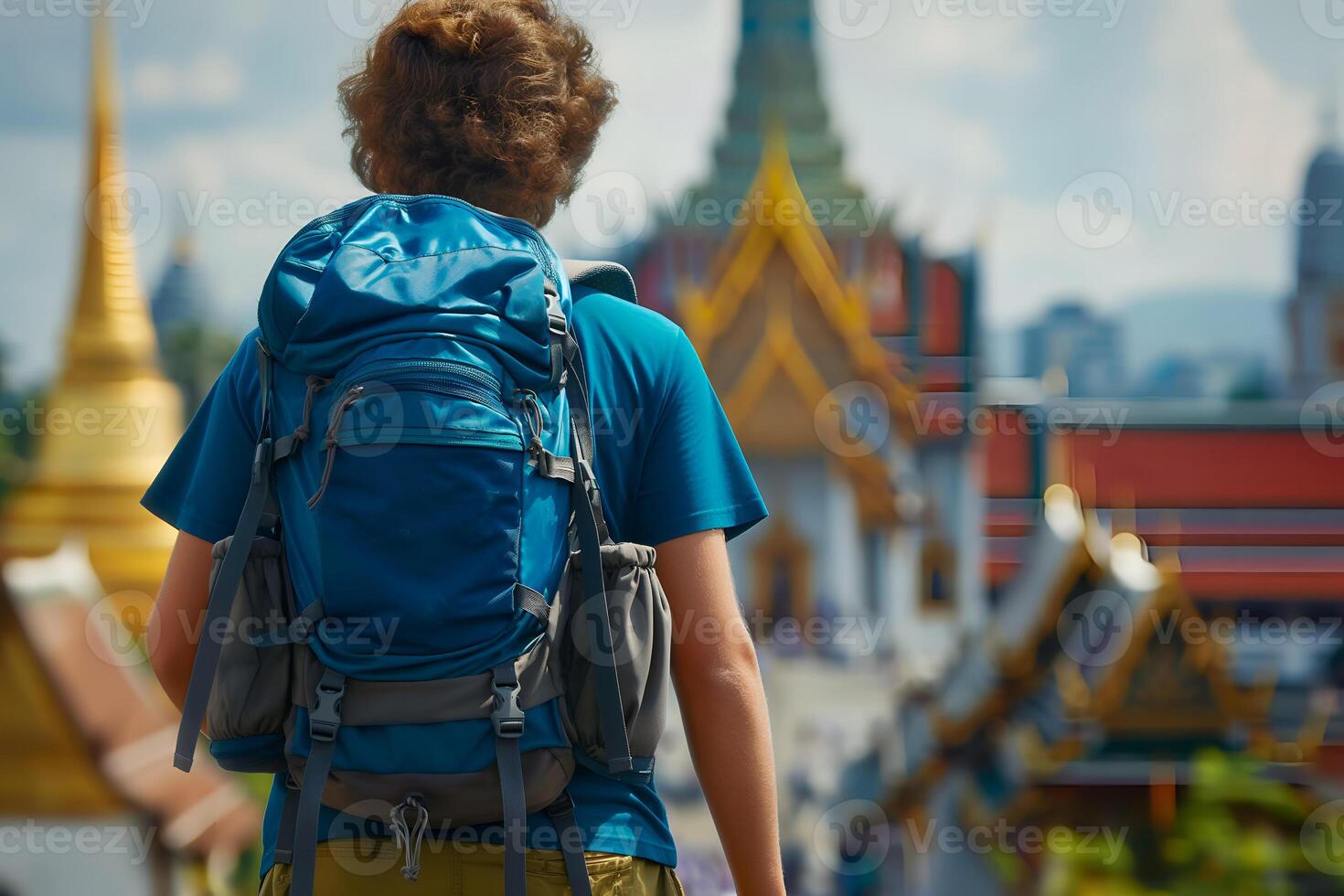Back view of a traveler man with backpack at Thailand pagoda photo