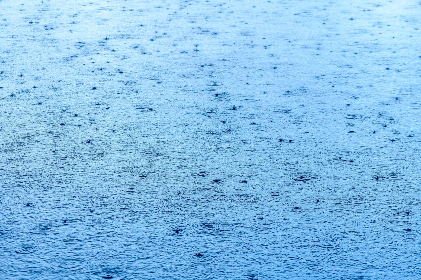 Defocus blurred transparent blue colored clear calm water surface texture with splashes and bubbles.2 photo