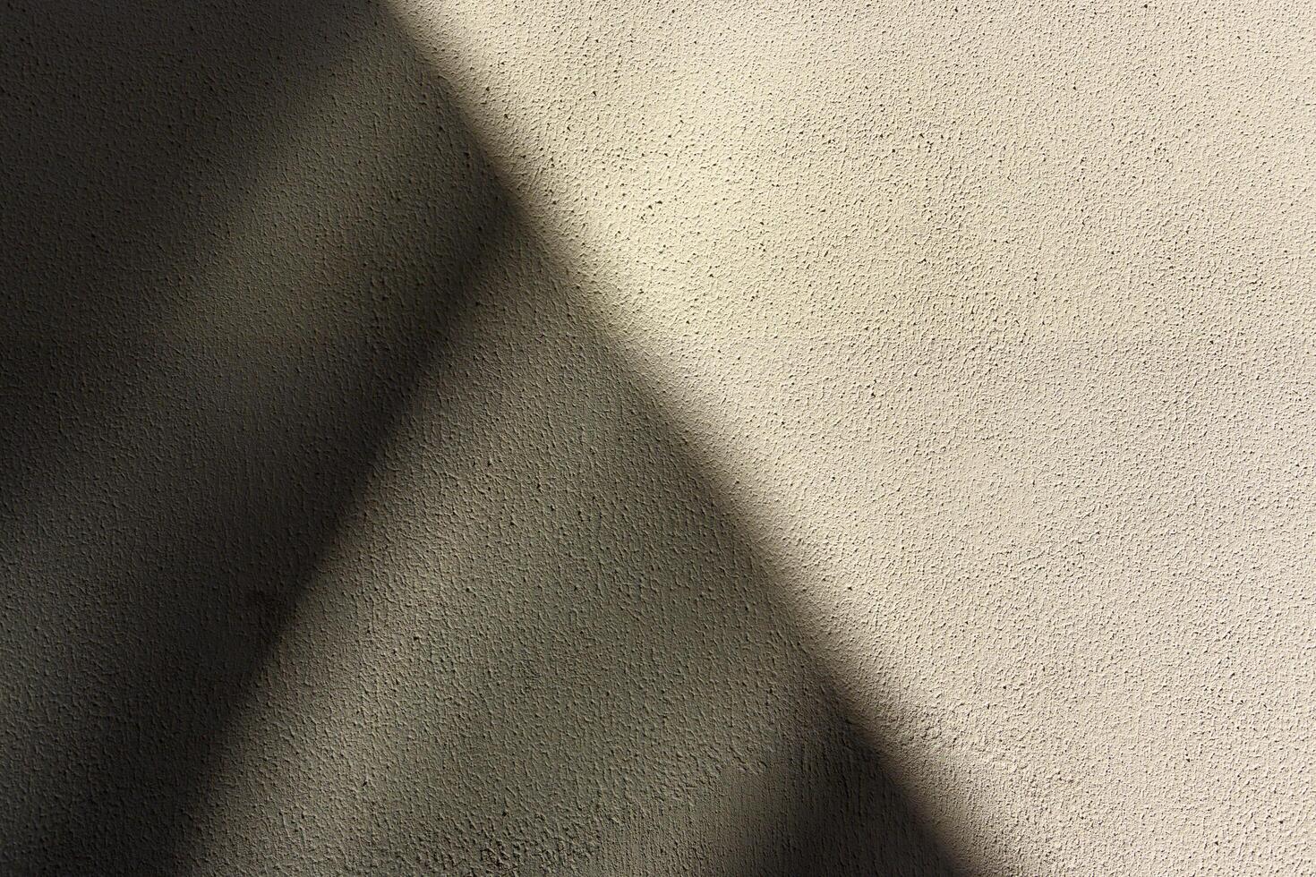 Full frame of a bright sunny orange wall with shadows and texture background photo