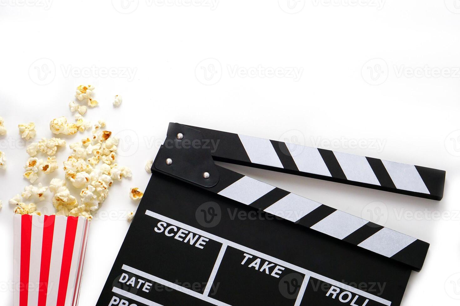 Clapperboard or movie slate black color with popcorn on white background. Cinema industry, production and film concept. photo