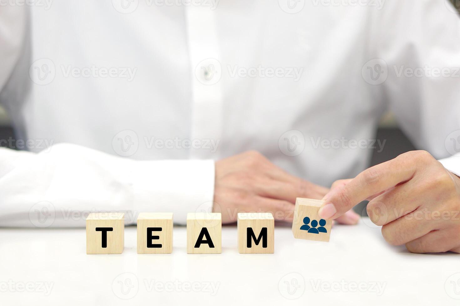 Businessman holding wooden block with text. Teamwork, team management, work in cooperation and business process concept. photo