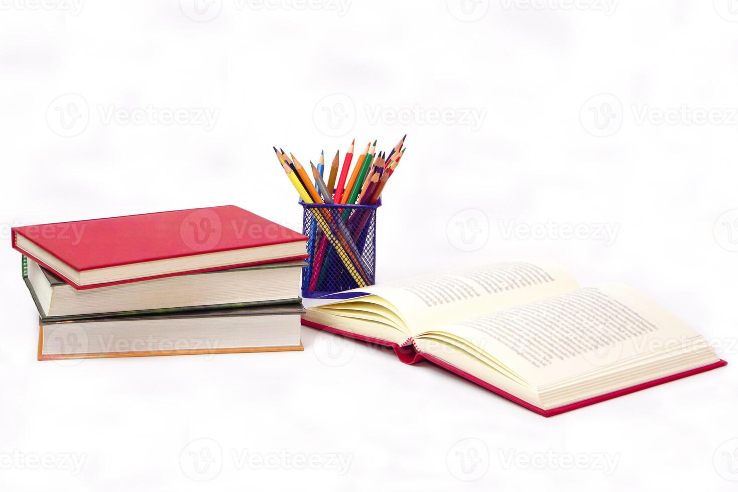 Crayon or colored pencils in box and the book placed in the blurred background. Knowledge and education concept. photo