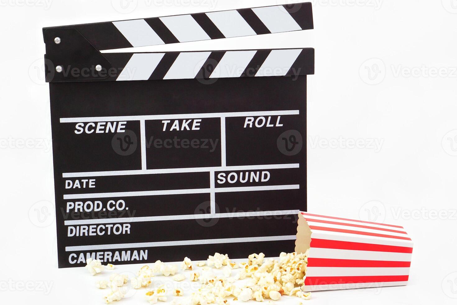Clapperboard or movie slate black color with popcorn on white background. Cinema industry, production and film concept. photo