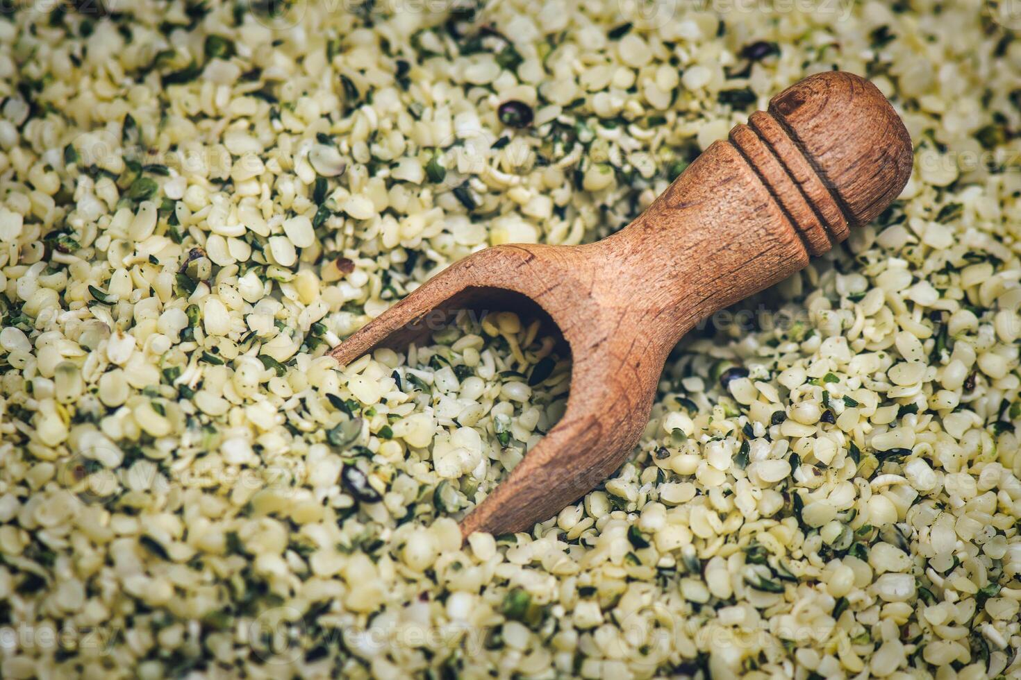 Detail of hemp seeds with wooden scoop photo