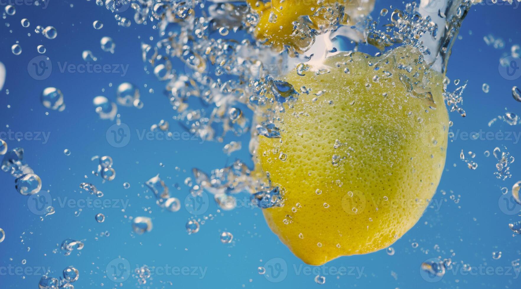 Underwater lemon slice in soda water or lemonade with bubbles. photo