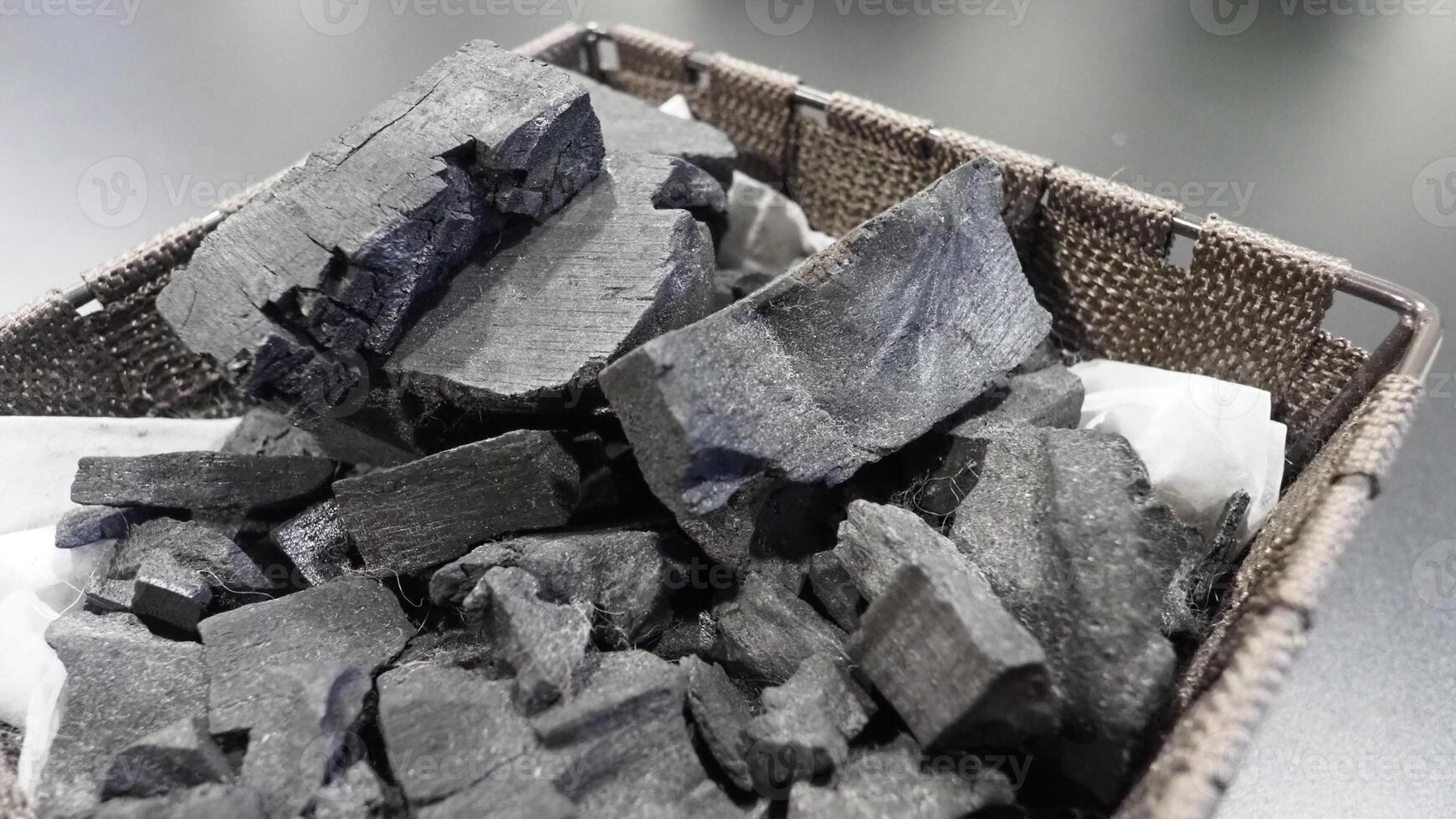 Natural wood charcoal traditional charcoal or hard wood charcoal on wooden table top view. photo
