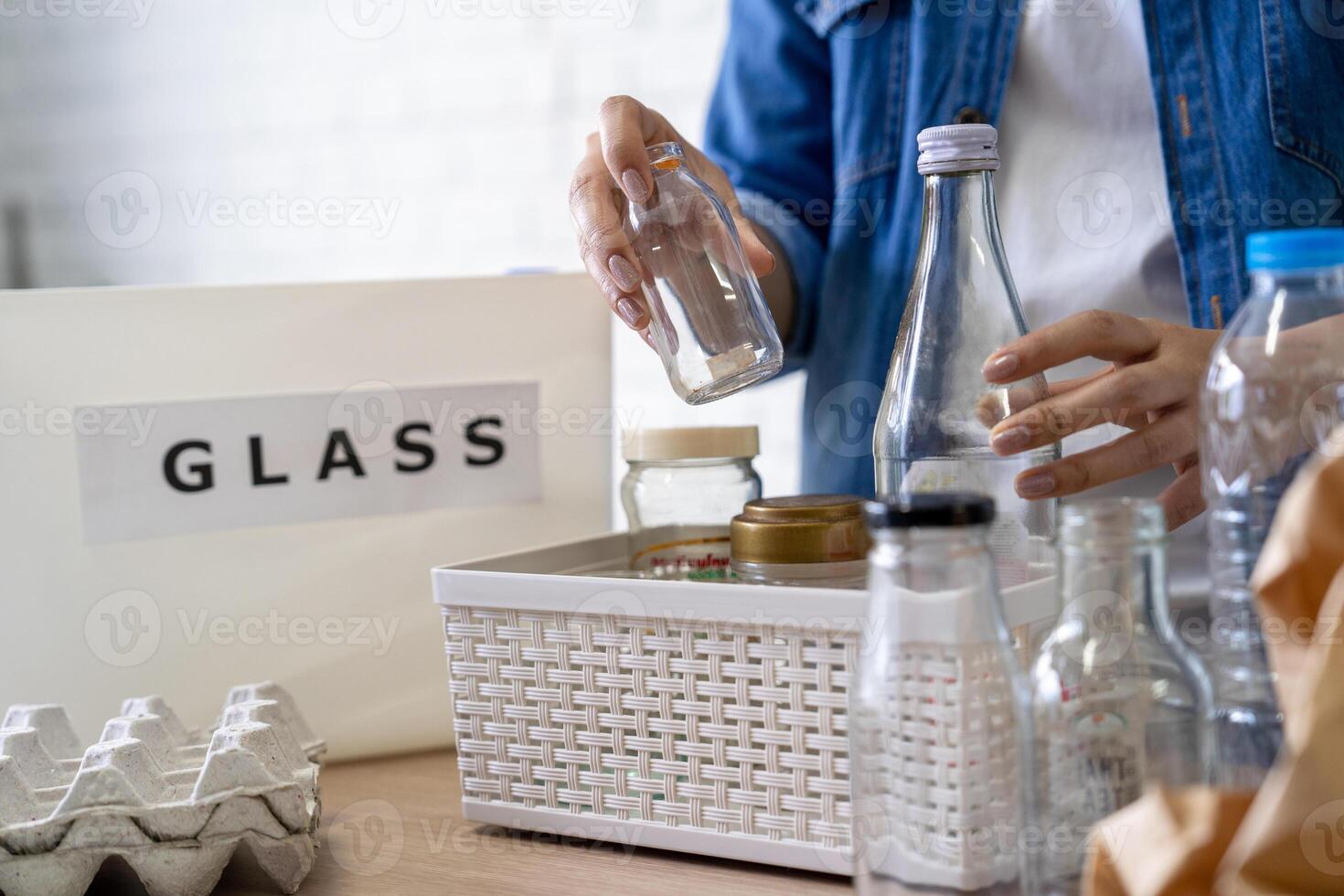 Man separating glass in container for recycling photo