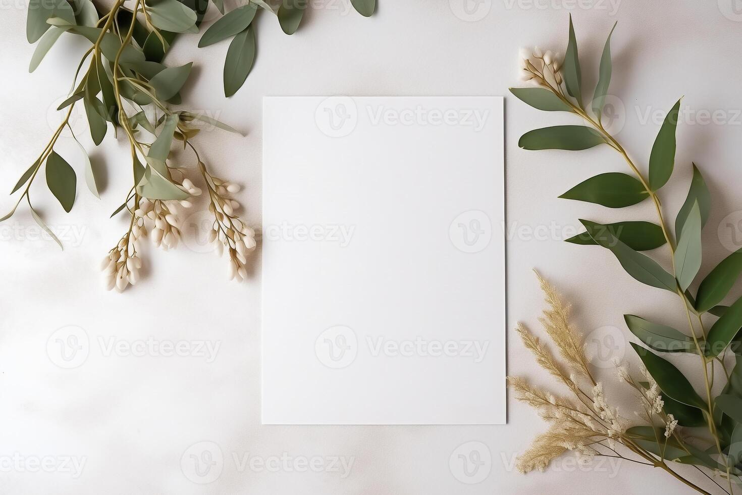 Wedding invitation or card mockup. Blank white sheet of copy space on a natural stone surface, decorative twigs with leaves. photo