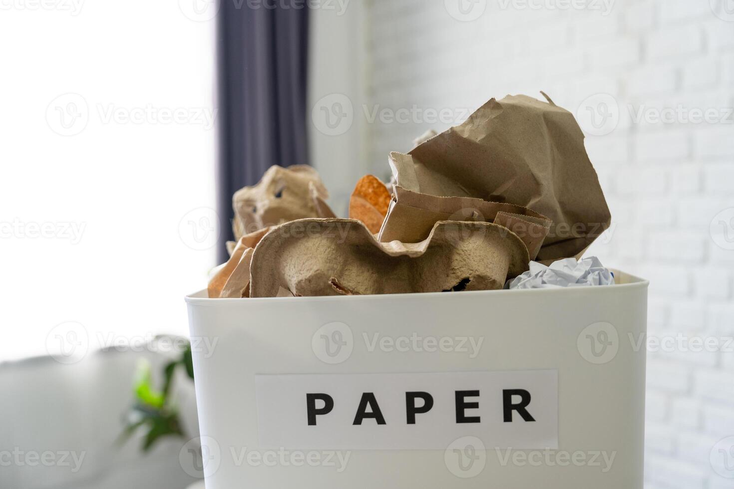 Photo of a box full of recycled paper cups in a home.