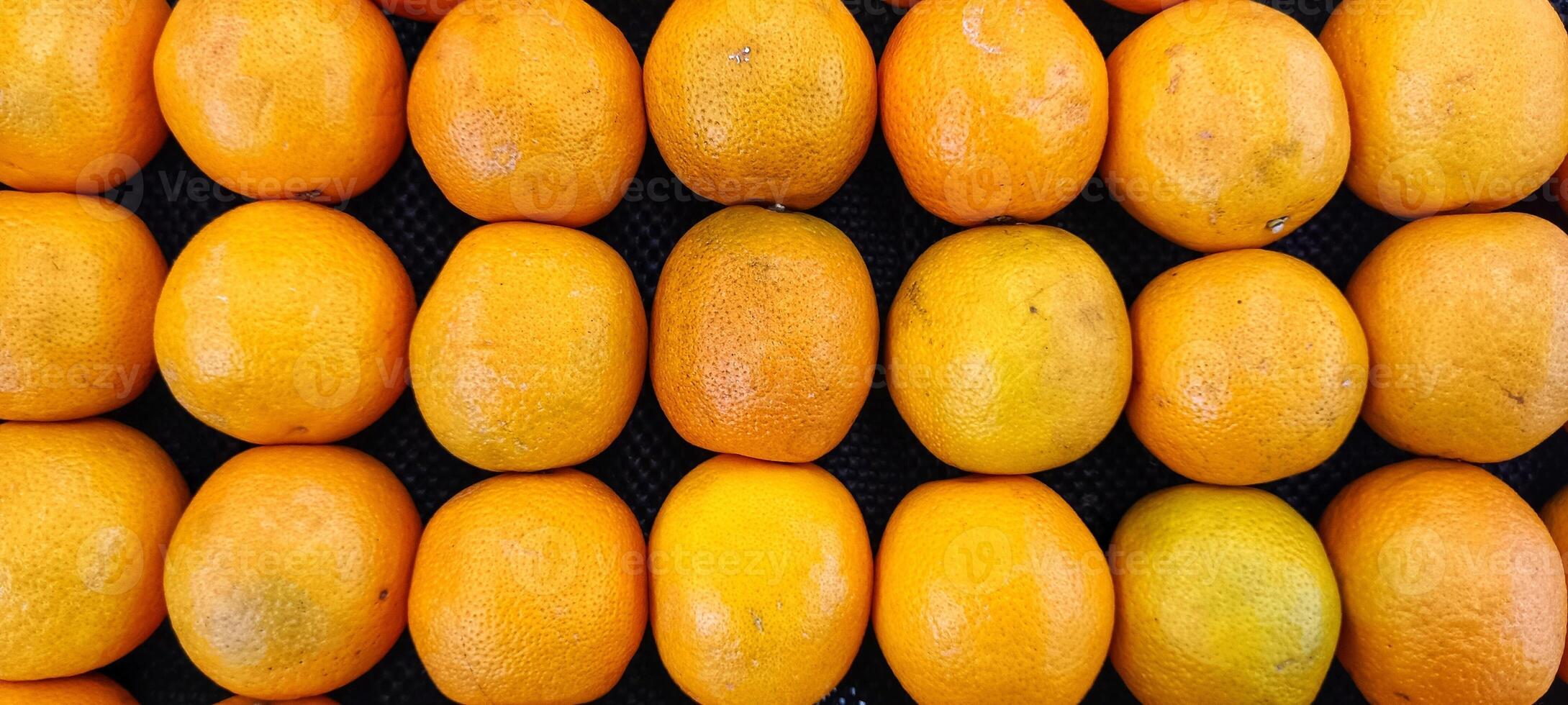 piles of fresh, fragrant oranges citrus in the supermarket photo