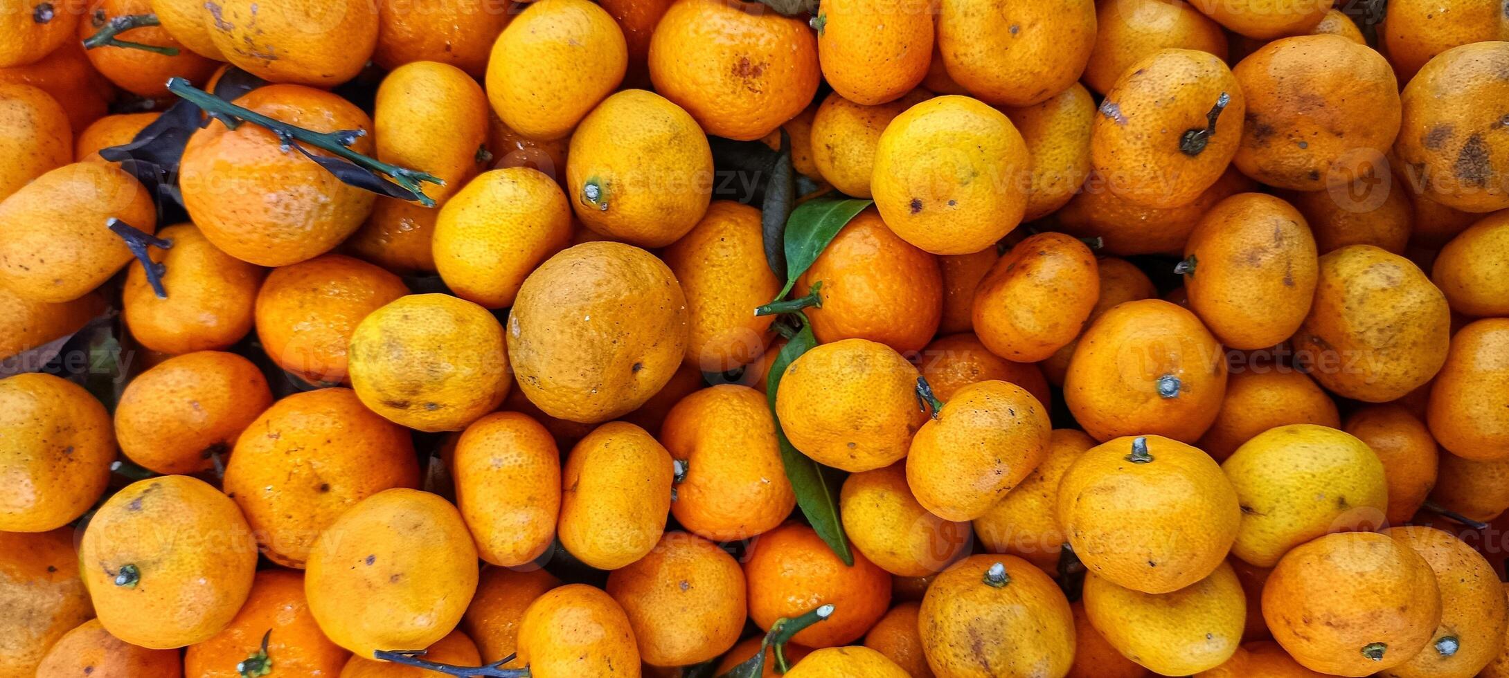 piles of fresh, fragrant oranges citrus in the supermarket photo