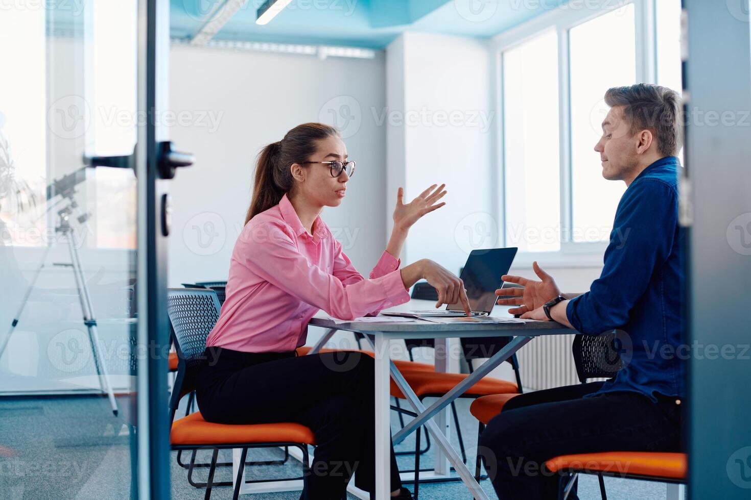 A furious business director of a startup office berating her employee for business mistakes and errors photo