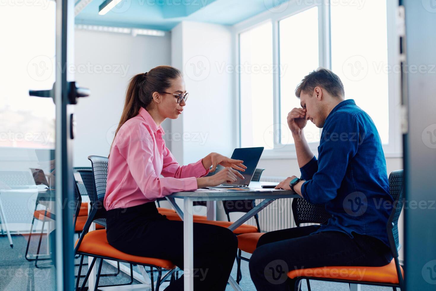 A furious business director of a startup office berating her employee for business mistakes and errors photo