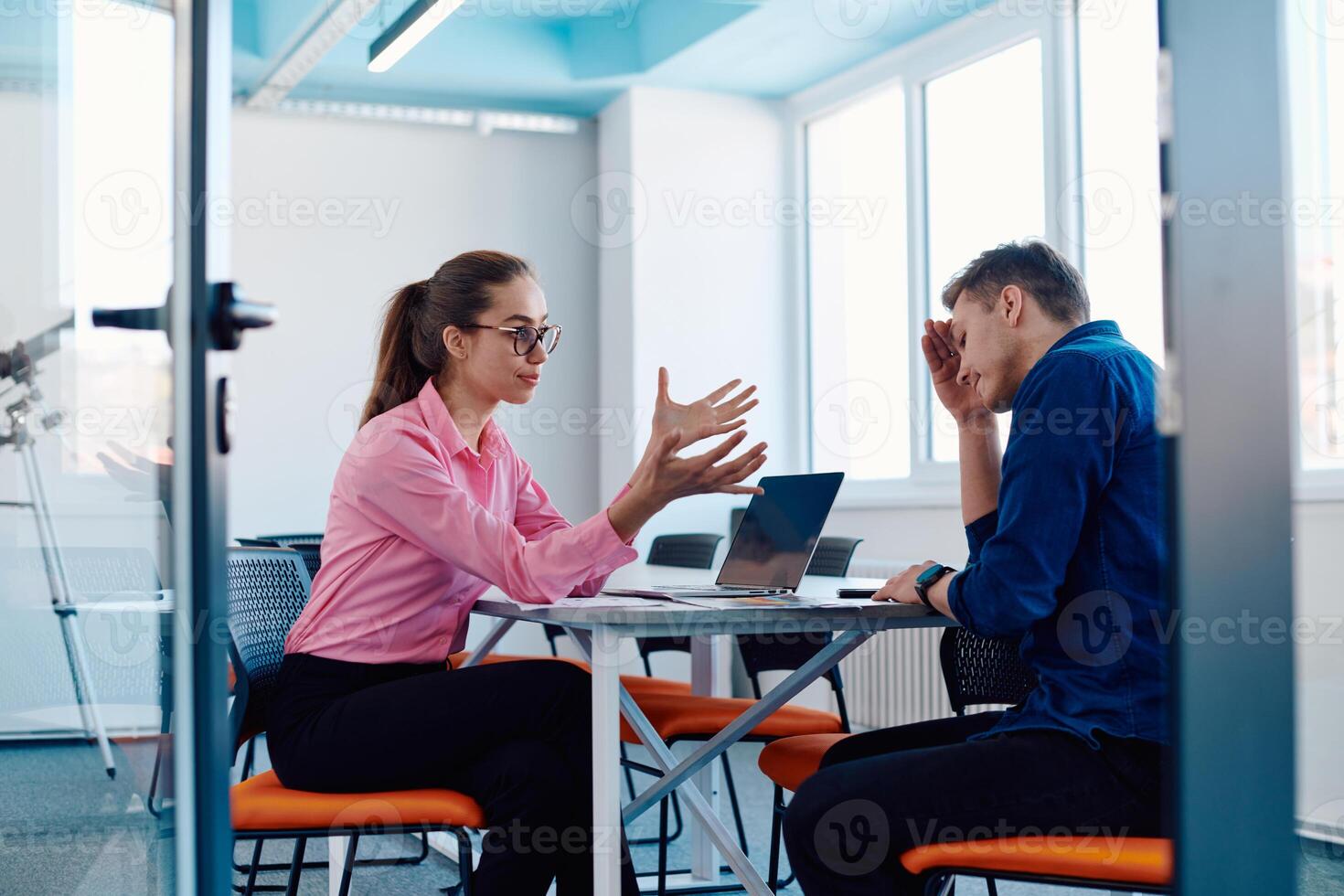 A furious business director of a startup office berating her employee for business mistakes and errors photo