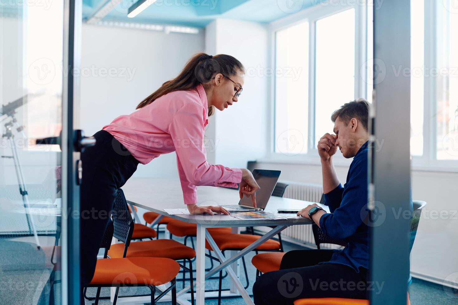 A furious business director of a startup office berating her employee for business mistakes and errors photo
