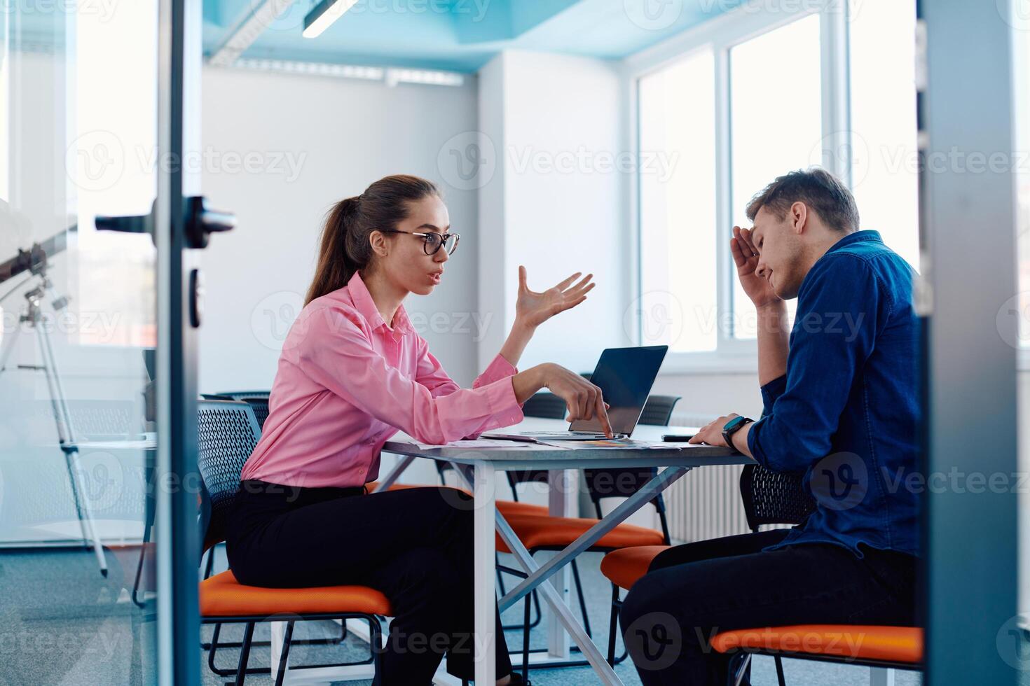 A furious business director of a startup office berating her employee for business mistakes and errors photo
