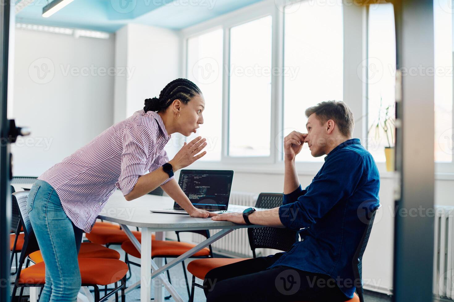 A furious business director of a startup office berating her employee for business mistakes and errors photo