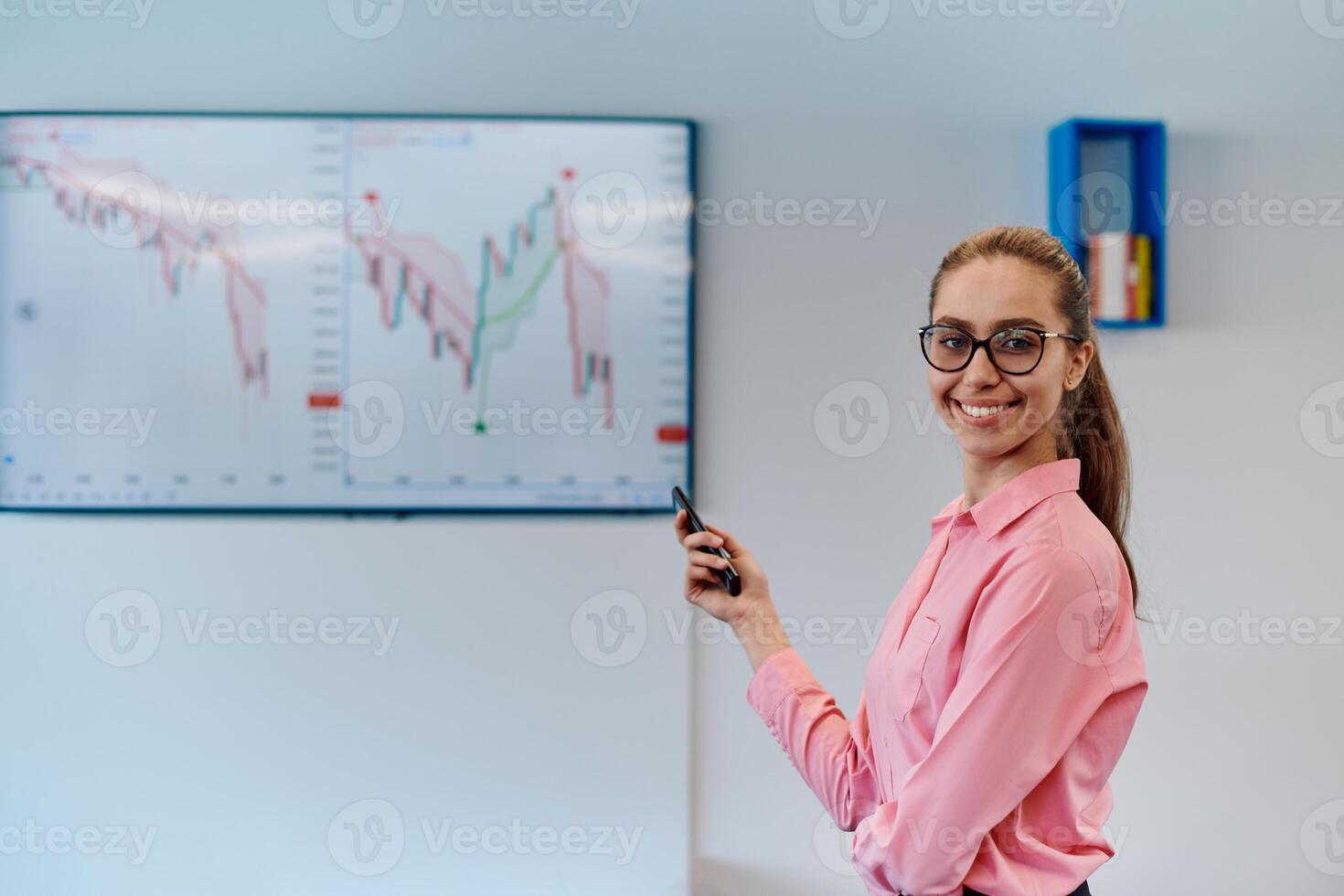 On Stage, Successful Female Speaker Presents Technological Product, Uses Remote Control for Presentation, Showing Infographics, Statistics Animation on Screen. Live Event Device Release photo