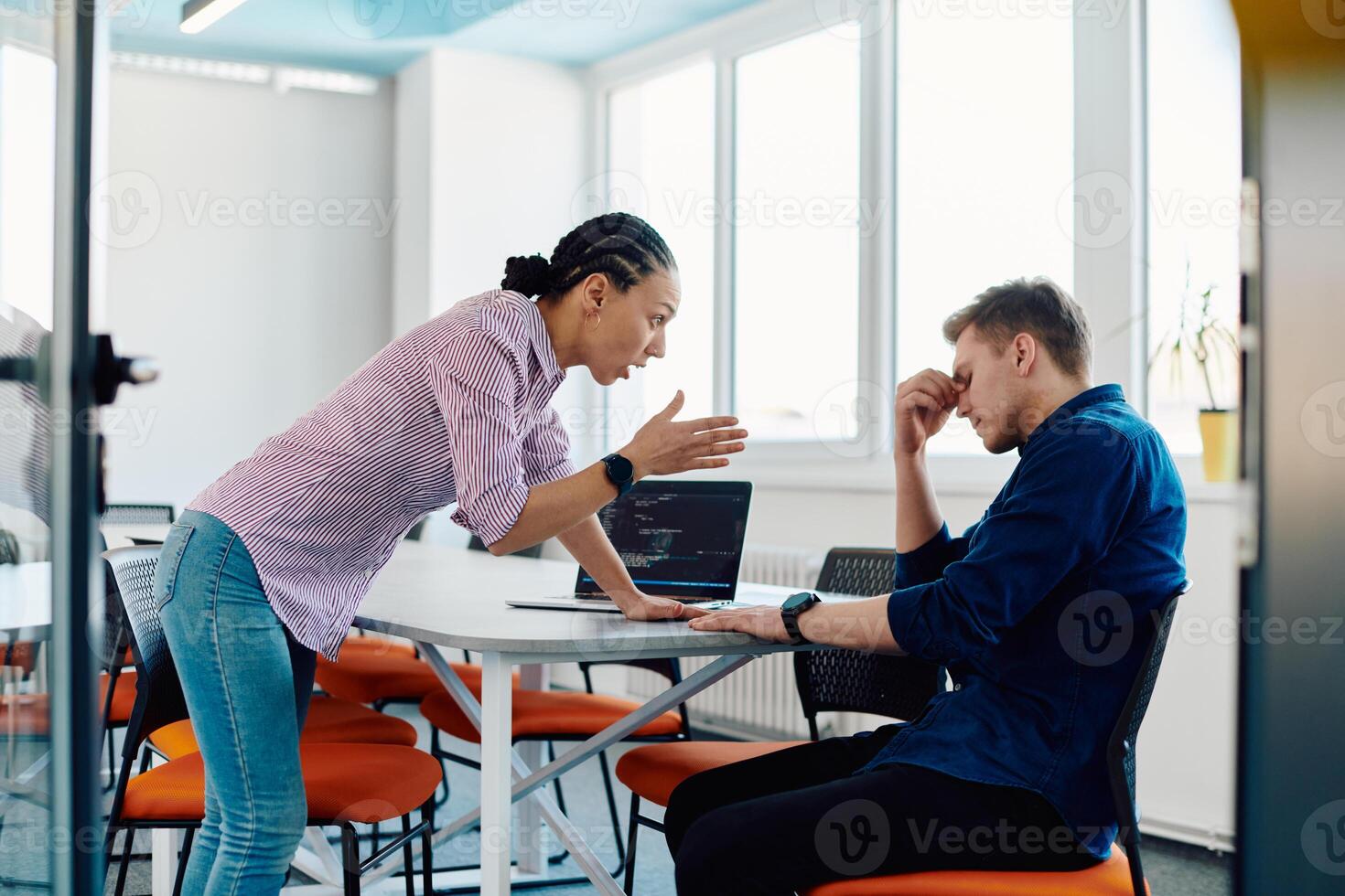 A furious business director of a startup office berating her employee for business mistakes and errors photo