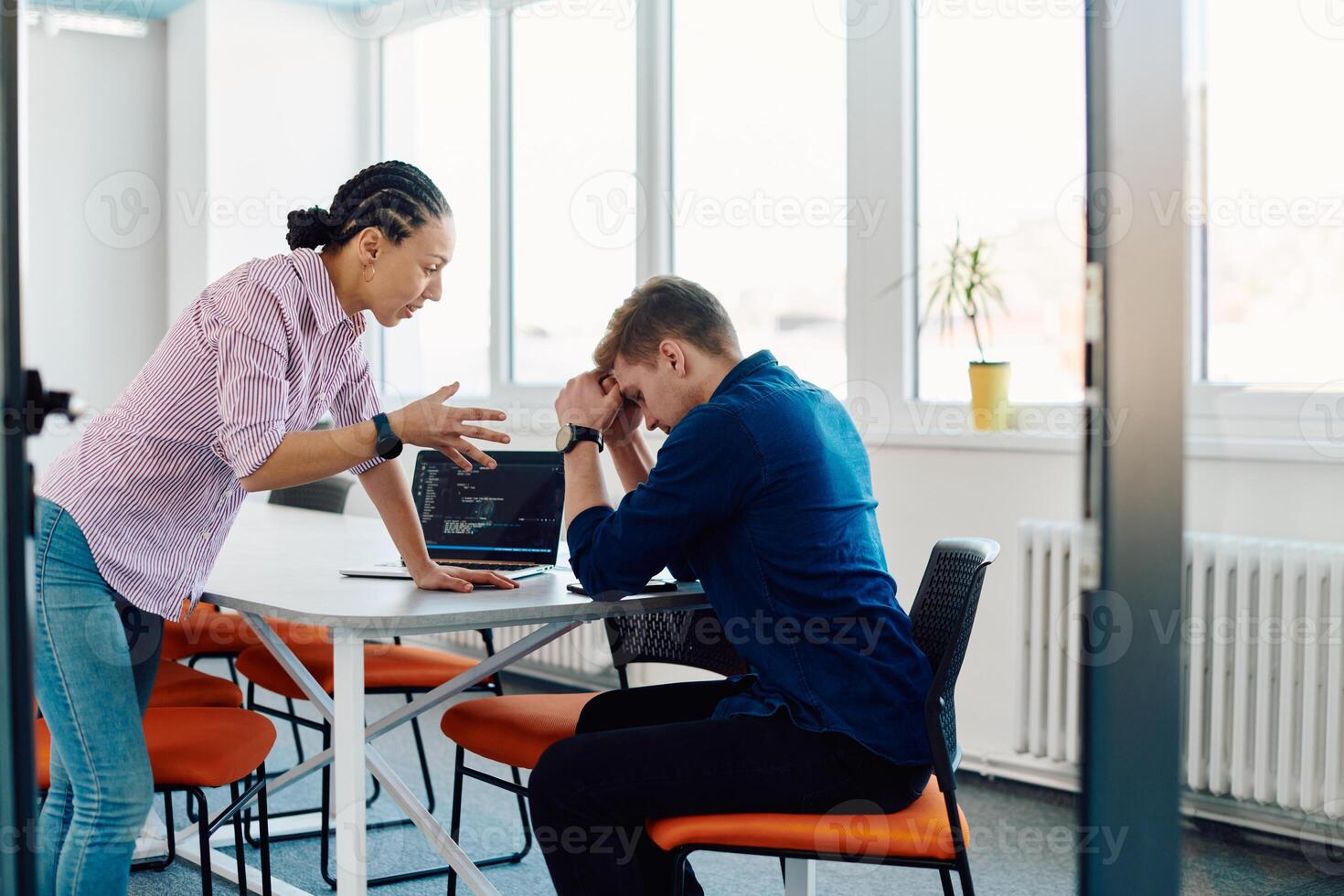 A furious business director of a startup office berating her employee for business mistakes and errors photo