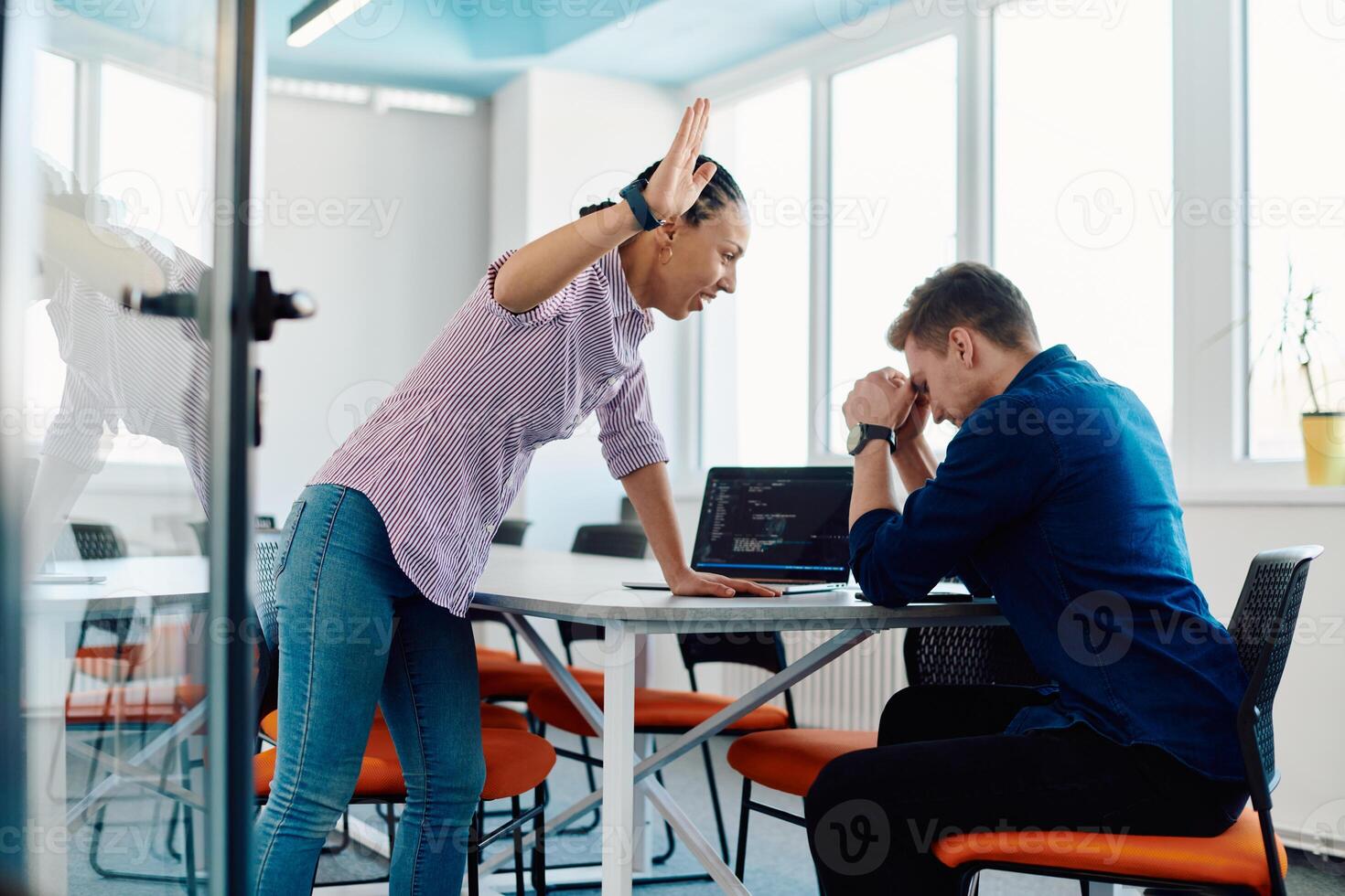 A furious business director of a startup office berating her employee for business mistakes and errors photo