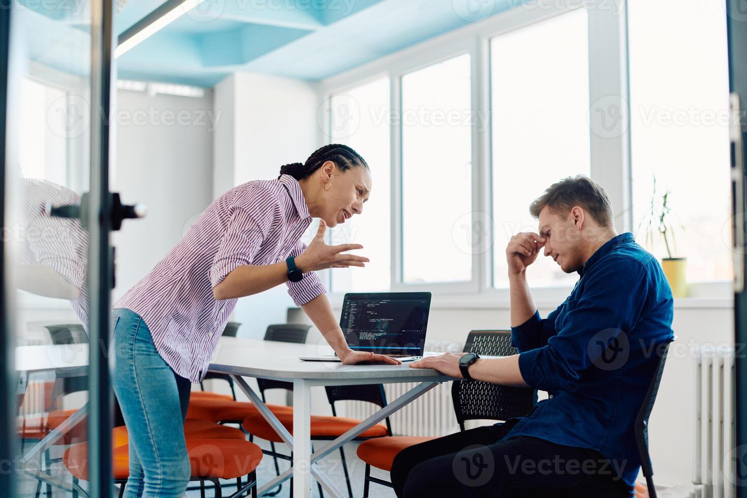 A furious business director of a startup office berating her employee for business mistakes and errors photo