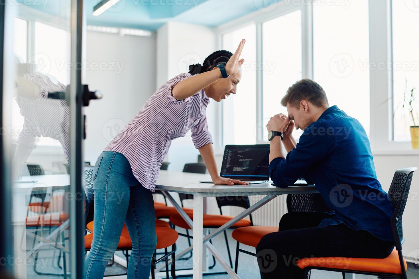 A furious business director of a startup office berating her employee for business mistakes and errors photo