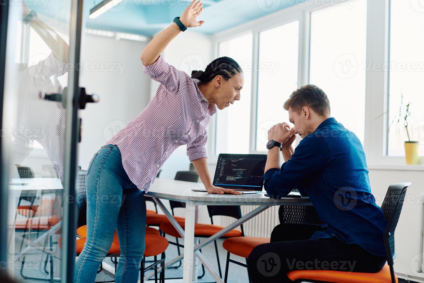 A furious business director of a startup office berating her employee for business mistakes and errors photo