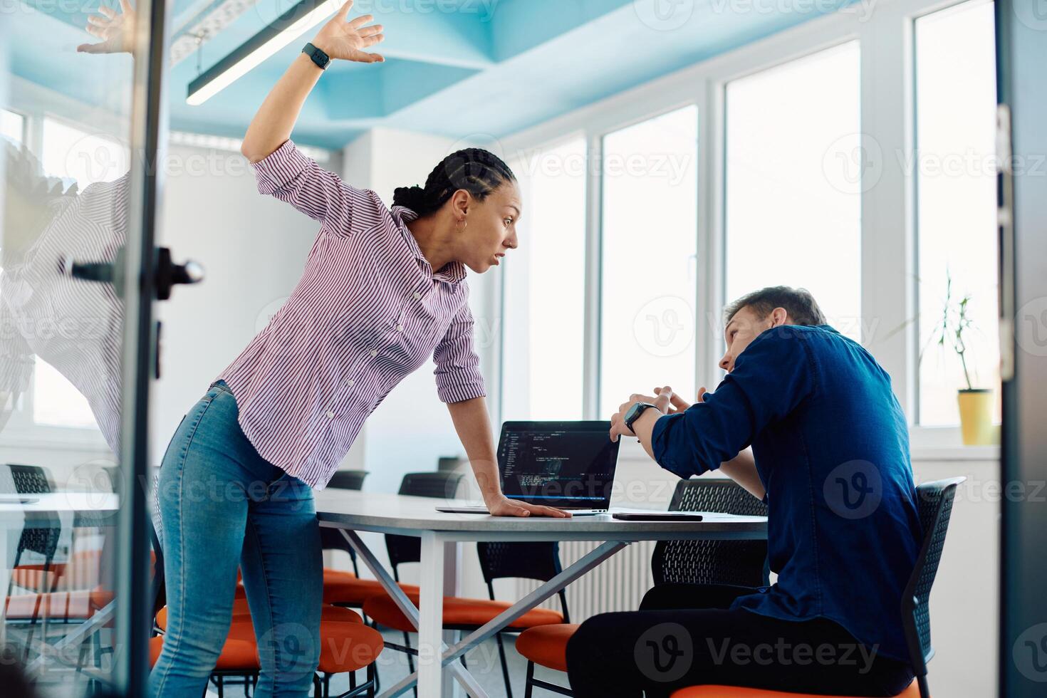 A furious business director of a startup office berating her employee for business mistakes and errors photo