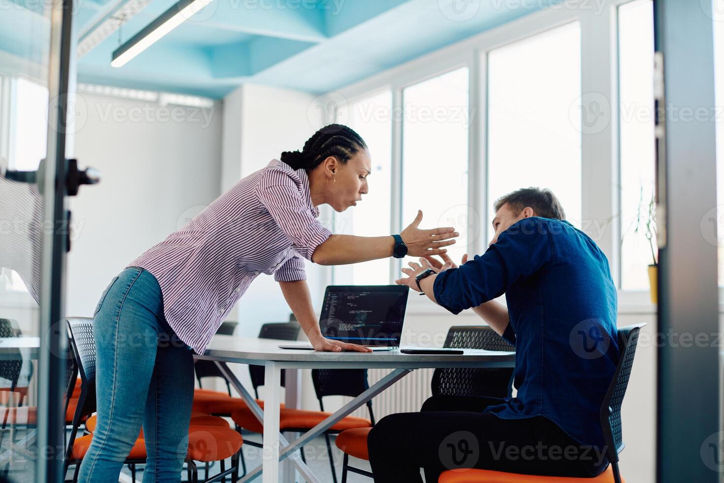 A furious business director of a startup office berating her employee for business mistakes and errors photo
