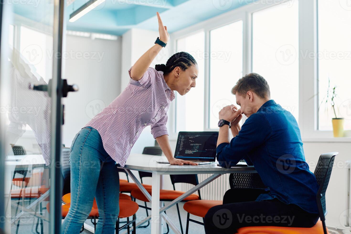 A furious business director of a startup office berating her employee for business mistakes and errors photo