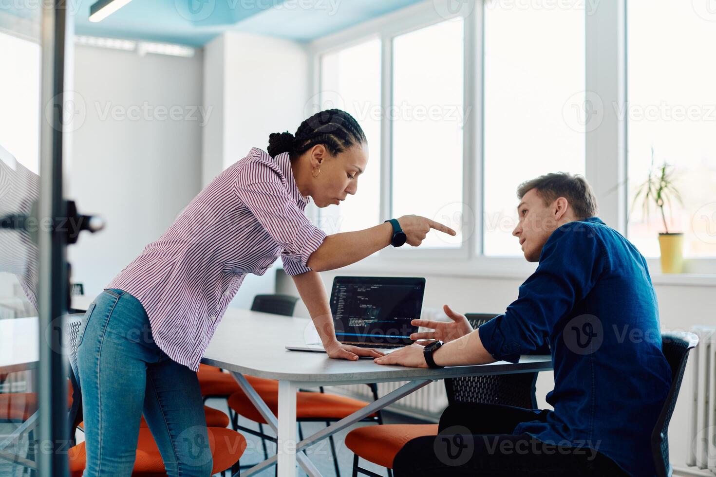 A furious business director of a startup office berating her employee for business mistakes and errors photo