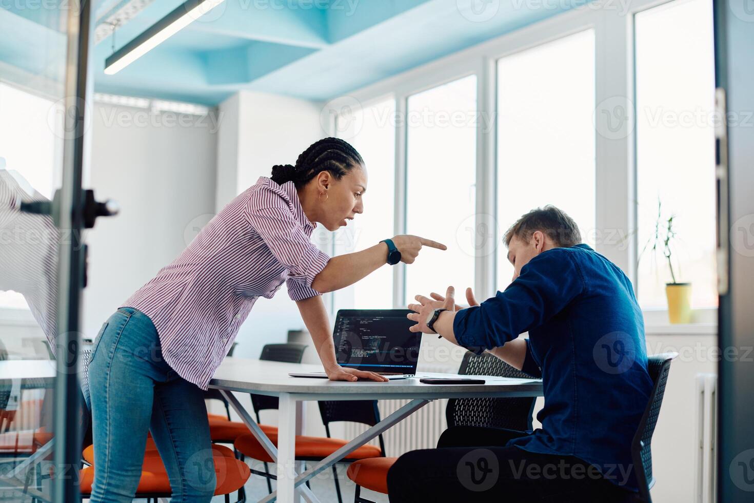 A furious business director of a startup office berating her employee for business mistakes and errors photo