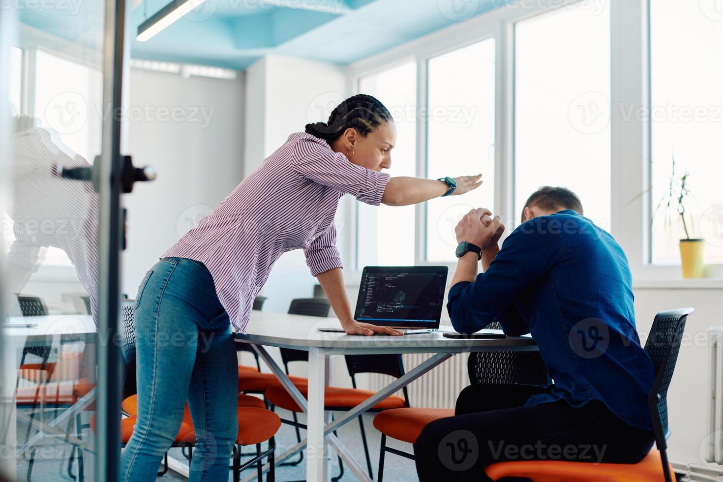 A furious business director of a startup office berating her employee for business mistakes and errors photo