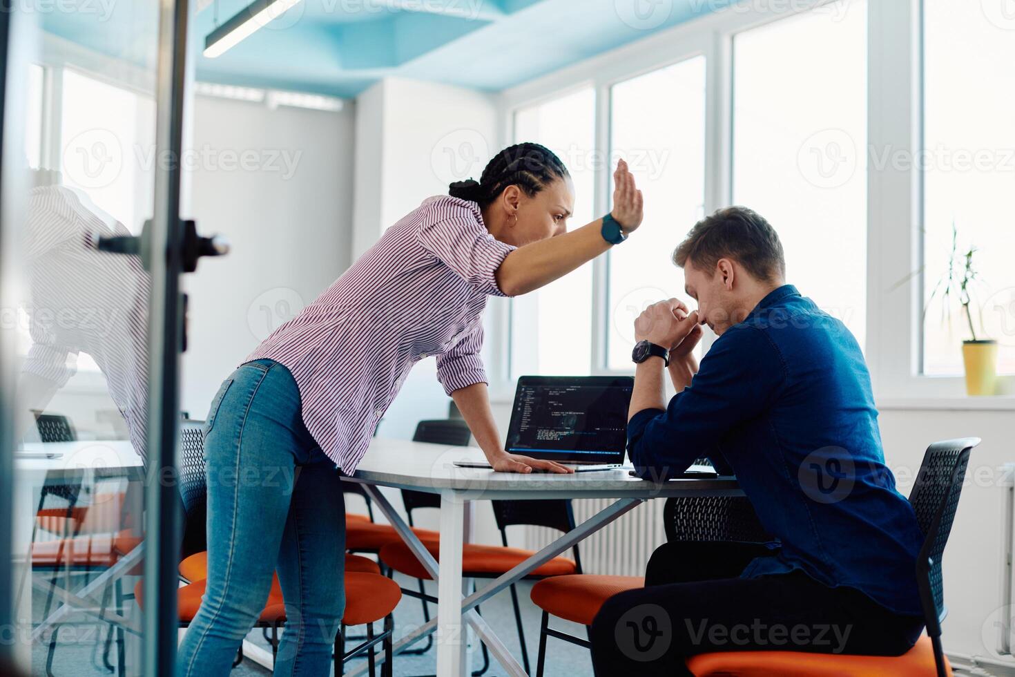 A furious business director of a startup office berating her employee for business mistakes and errors photo